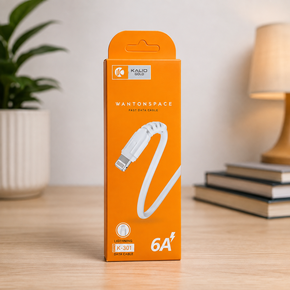 Wantonspace K-301 Lightning 6A fast data cable orange retail box standing on wooden desk with plant and lamp in background