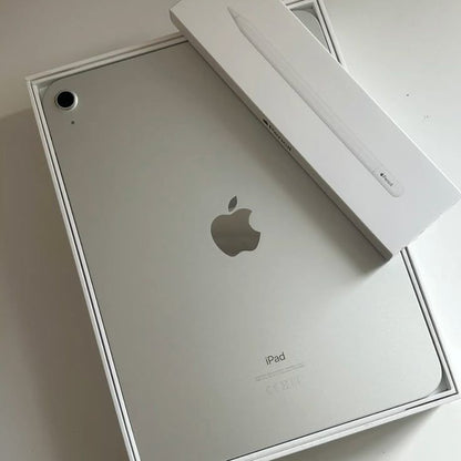 Apple iPad Silver back view in original box with Apple Pencil box on white surface