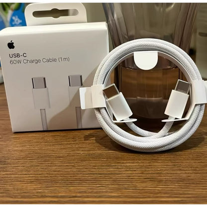 Apple USB-C 60W Charge Cable 1m braided white cable unboxed coiled in front of original box on wooden surface
