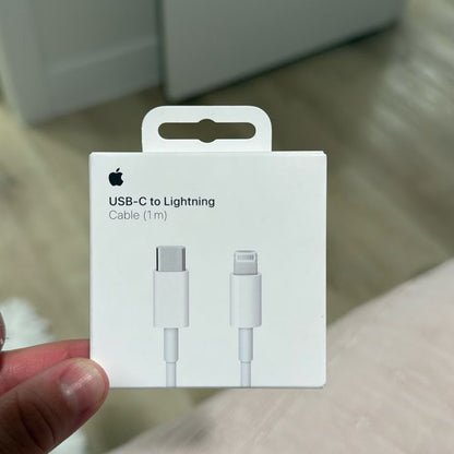 Apple USB-C to Lightning Cable 1m original white retail box held in hand showing Apple logo and cable illustration