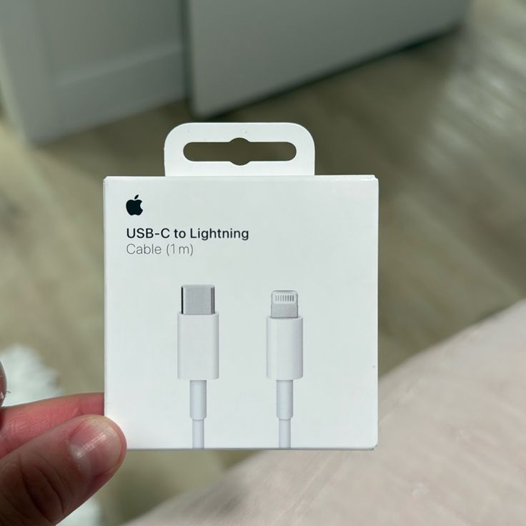 Apple USB-C to Lightning Cable 1m original white retail box held in hand showing Apple logo and cable illustration