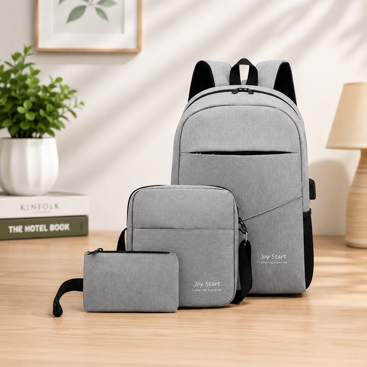Joy Start 3-in-1 backpack set gray color lifestyle shot on wooden desk with plant and books in background