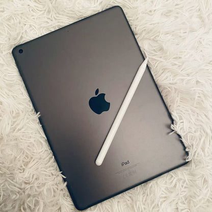 Apple iPad 9th Generation Space Gray back view with Apple Pencil on white fluffy surface