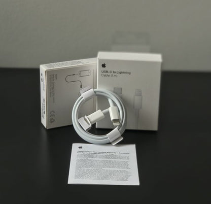Apple USB-C to Lightning Cable 1m unboxed with original white Apple box and warranty card on dark surface