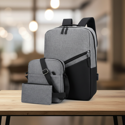 Premium 3-in-1 two-tone laptop backpack set gray and black showing backpack crossbody bag and wallet pouch on wooden table with blurred cafe background