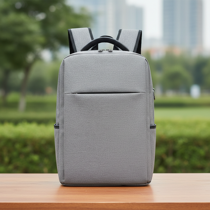 Classic minimalist laptop backpack light gray front view on wooden table with green park background showing top handle and front zip pocket